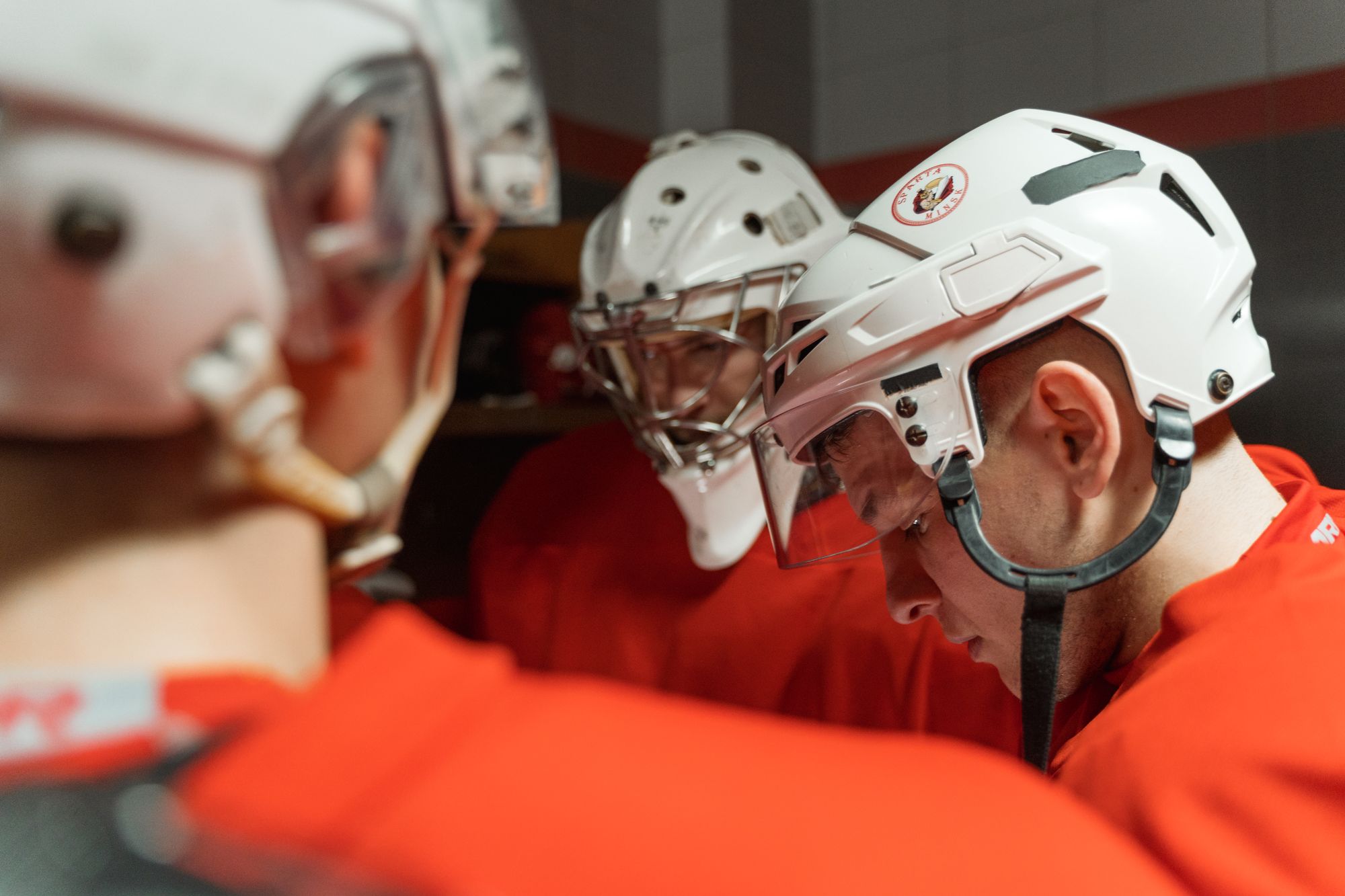 Hockey players in a dressing-room huddle