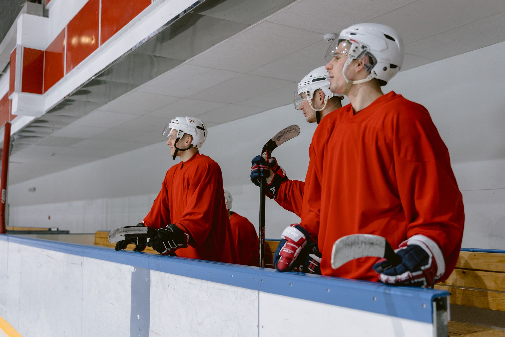 Players standing at the rink boards